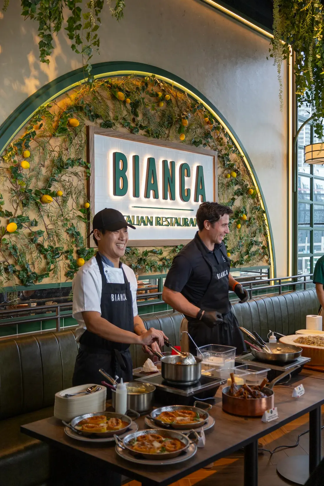 Bianca chefs cooking in front of the Bianca sign